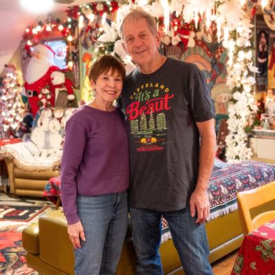 A couple stands in their decorated home