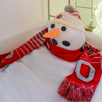 A melting snowman in a bath tub